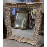 A rectangular white painted ornate mirror, 19" x 15 1/2"
