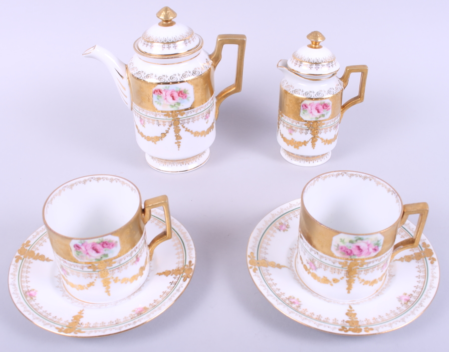 An Austrian gilt and floral decorated part coffee set, eight pieces