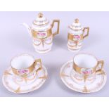 An Austrian gilt and floral decorated part coffee set, eight pieces