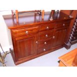 A fruitwood sideboard, fitted six drawers flanked two side cupboards, on block base, 52" wide