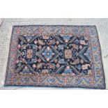 A Herati design rug on a dark blue ground, 38" x 55" approx (slight moth damage)