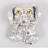 A white metal brooch, in the form of a dog's head with a bone, stamped 925 sterling, 1 1/4" long