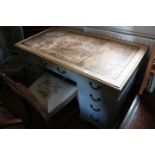 An oak pale blue painted double pedestal desk with leather top, fitted nine drawers, on bracket