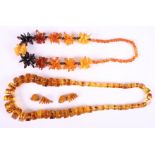 A tri-colour amber necklace, including butterscotch and cherry, formed as flowers, a similar