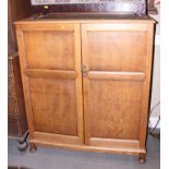 An oak "Compactum" wardrobe with fitted interior enclosed panelled doors, 48" wide