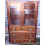 A mahogany display cabinet enclosed two glazed doors over three drawers, on block base, 30" wide