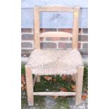 A child's pine rush seat chair and a toboggan