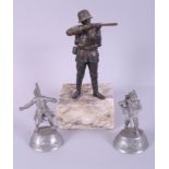 A bronzed figure of a WWI German soldier, on marble base, and two pewter figures of soldiers