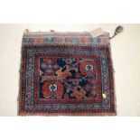 A Caucasian tribal saddle bag with rosette design on a blue ground, 22" x 19 1/2" approx