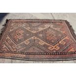 A Persian kelim rug with all-over diamond design in shades of brown, pink, black and natural, 83"