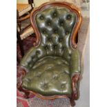 A 19th century mahogany showframe armchair, button upholstered in a green leather, on cabriole