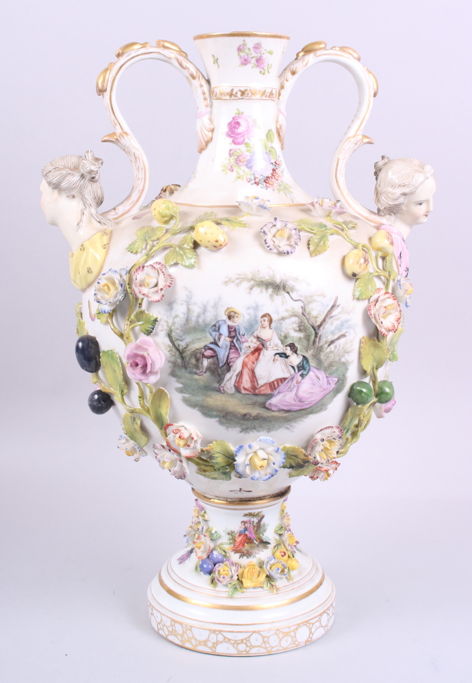 A two-handled vase, decorated fruit and flowers in high relief, with two painted panels of