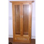 A modern light oak display cabinet enclosed two glazed panel doors, 36" wide