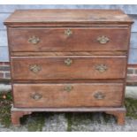 A late Georgian oak and chestnut chest of three long drawers, on bracket feet, 42" wide