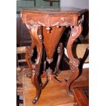 A Victorian rosewood octagonal sewing table with fitted interior, on carved cabriole supports, 17