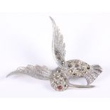 A white metal and marcasite brooch, in the form of a hummingbird with gem set eye, stamped 925