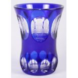 An Austrian etched and overlaid blue glass waisted beaker, decorated architectural panels, 5 1/4"