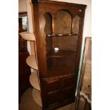 A dark oak corner display cabinet, fitted open shelves over two doors, on block base, 29" wide