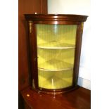 A mahogany and gilt metal mounted bowfront corner display cabinet
