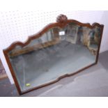 An early 20th century walnut shape frame mirror with bevelled glass and shell finial, 29 1/2" wide