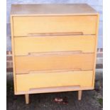 A Stag light oak chest of four long drawers, on turned supports, 30" wide