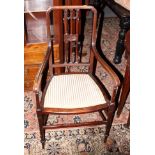 An Edwardian mahogany armchair with floral upholstered seat, on turned and stretchered supports, and