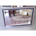A wall mirror with beveled plate 29" X 19 1/2"