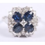 A sapphire and diamond ring, in the form of a flower, mounted in white metal, stamped 18ct, size Q