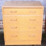 A 1950s oak chest of four long graduated drawers, on block base, 30" wide