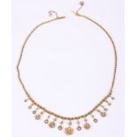 A 1920s floral drop necklace, set seed pearls mounted in yellow metal, stamped 15ct, with attached