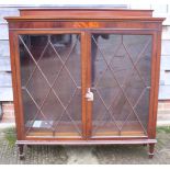 An Edwardian mahogany, box and ebony string inlaid bookcase enclosed lattice glazed doors, on square