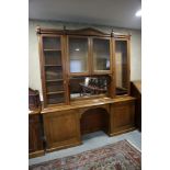 A late Victorian Aesthetic Movement ash, box and ebony inlaid bookcase enclosed four glazed doors