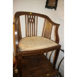 An Edwardian walnut and line inlaid elbow chair with Gothic pierced splat back, on square taper