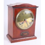 A 1920s polished as walnut mantel clock with brass dial, 19" high
