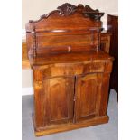 An Edwardian mahogany chiffonier with carved ledge back over one long drawer and cupboards, on block
