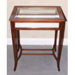 An Edwardian mahogany and inlaid bijouterie table with bevelled glass top, on square splayed