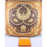 A Hermes silk scarf, "Les Cavaliers d'Or", designed by Vladmir Rybaltchenko (Rybal), complete with