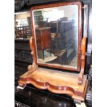 A Victorian mahogany swing frame toilet mirror, on plateau base with scroll feet, 24" wide