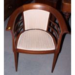 An Edwardian mahogany and inlaid tub seat bedroom chair, upholstered in a floral fabric, on square