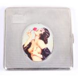 An engine turned silver cigarette case with applied panel of a scantily clad woman, 3 1/4" wide