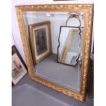 An ornate gilt framed wall mirror with bevelled glass, plate 39 1/2" x 29 1/2"