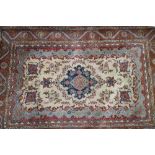An Isfahan rug with central medallion and birds on a white ground and floral and scroll borders in