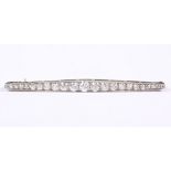 A diamond bar brooch set single row of old mine cuts, mounted in white metal