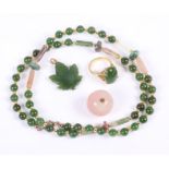 A nephrite cabochon ring, a similar necklace, a pendant and a rose quartz bead