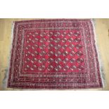 A Bokhara rug with forty-eight guls on traditional shades, 68" x 67" approx