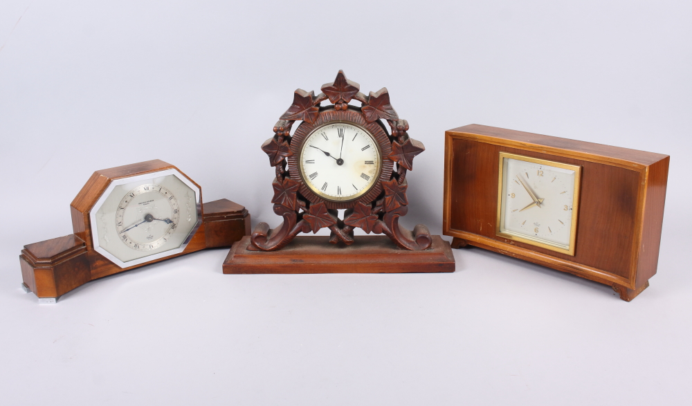A carved oak mantel clock with Roman numerals, 9" high, and two mid 20th century mantel clocks