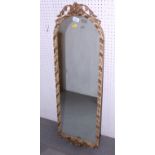 An early 20th century arch top wall mirror with gilt scrollwork crest, plate 35" x 11 1/2"