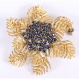 A sapphire cluster brooch, in yellow metal mount, stamped 750, formed as ferns