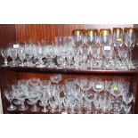 Six gilt rimmed etched champagne glasses, six matching wines, and a quantity of etched and cut table