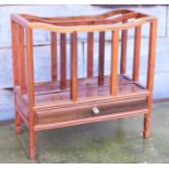 A Chinese rosewood canterbury, fitted one shallow drawer, on shaped supports, 18" wide